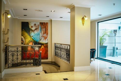a lobby with a large painting on the wall at Amérian Executive Córdoba Hotel in Cordoba