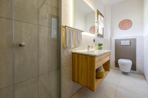 a bathroom with a sink and a toilet at Aral Tatil Ciftligi in Bozcaada