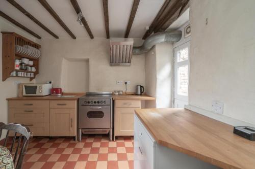 a kitchen with a stove and a counter top at Bank House | Peak District in Longnor