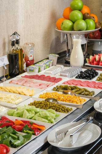 a buffet with different types of food on a table at Central Hotel Yerevan in Yerevan