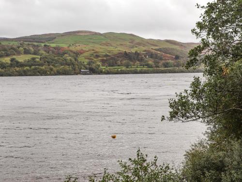 a large body of water with hills in the background at Llys Tirion in Bala