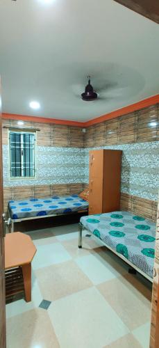 a room with two bunk beds in a room with a table at S.S.K RESIDENCY in Chennai