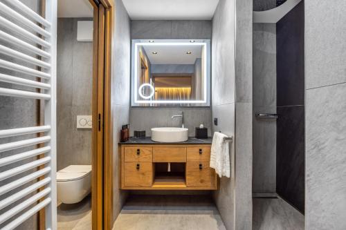 a bathroom with a sink and a toilet at Hotel Nordik Adults Only - Over 14 in Andalo