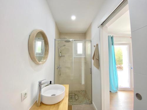 a bathroom with a sink and a shower at Harmony Home in Alcaucín