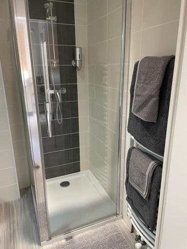 a shower with a glass door in a bathroom at À la maison in Saint-Étienne