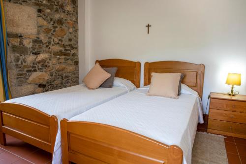 two beds sitting next to each other in a bedroom at Fonte dos Pepes by LovelyStay in Lamego
