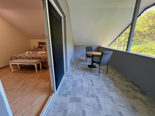 a room with a bed and a table and chairs at Villa Dora in Krapinske Toplice