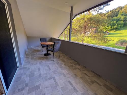 a room with a table and chairs and a large window at Villa Dora in Krapinske Toplice