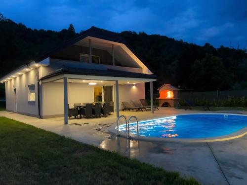 a house with a swimming pool at night at Villa Dora in Krapinske Toplice