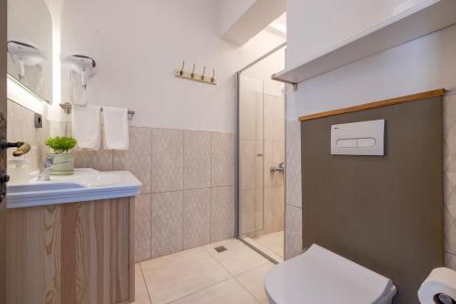 a bathroom with a toilet and a sink and a shower at Aral Tatil Ciftligi in Bozcaada