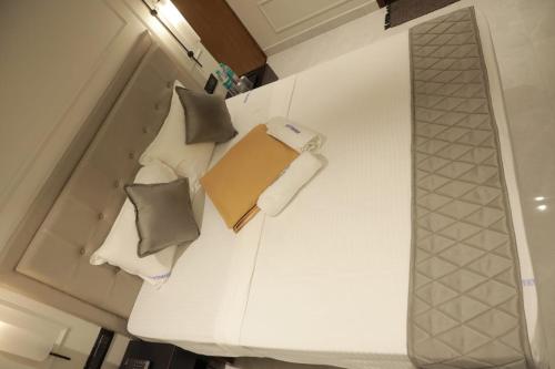 a bed with pillows and a box on top of it at ARUNACHALA INN in Kanyakumari