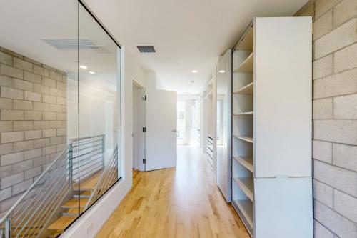 a hallway of a house with glass shelves at Modern Loft-Style Townhouse in Los Angeles in Los Angeles