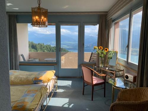 a bedroom with a bed and a desk and a table with a chair at Rooms Haltenegg in Heiligenschwendi
