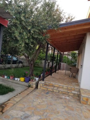 an outdoor patio with a wooden pergola at Vila Sita in Vlorë