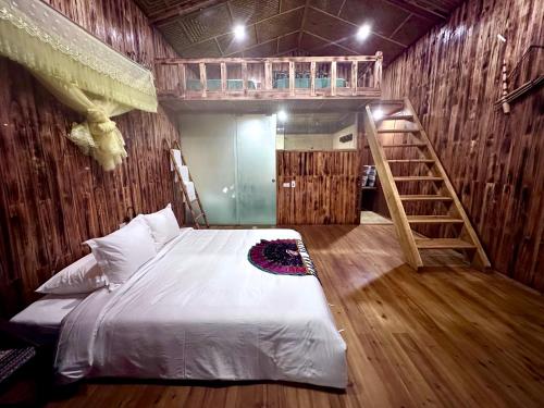 a bedroom with a bunk bed and a ladder at Bac Ha Charm Stay in Bắc Hà