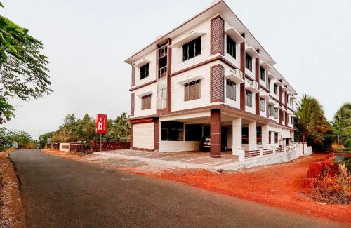 a large white building on the side of a road at SPOT ON Rohini Inn Kadampuzha in Malappuram