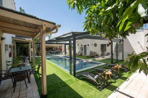 an external view of a house with a swimming pool at פרדייז ברמה in Had Nes