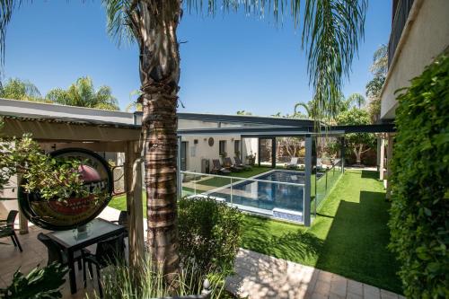 an external view of a house with a palm tree at פרדייז ברמה in Had Nes