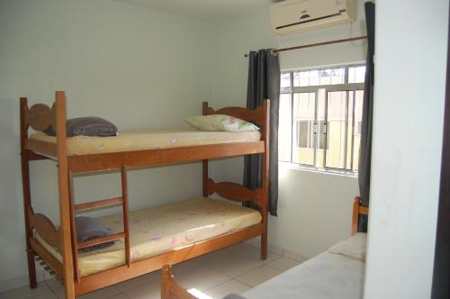 Una cama o camas cuchetas en una habitación  de Hotel Pousada Pereira