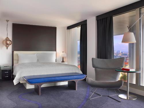 a hotel room with a bed and a chair at Le Meridien Istanbul Etiler in Istanbul