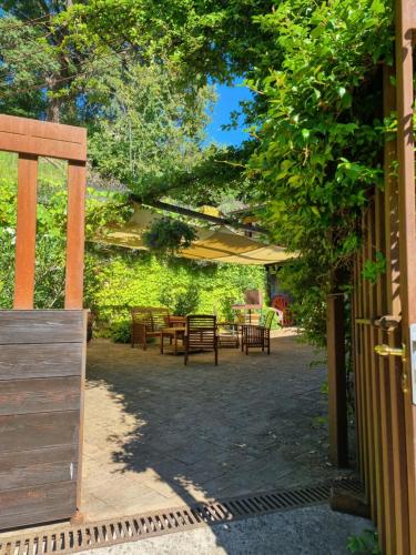 a patio with a table and chairs under a canopy at B&B Casa Zia Cianetta Residenza di Campagna in Capodacqua di Foligno