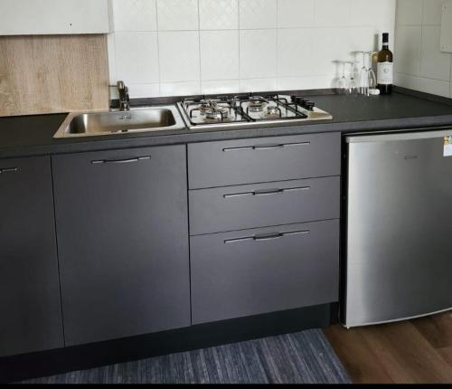 a kitchen with a sink and a stove at Casa Baveno in Baveno