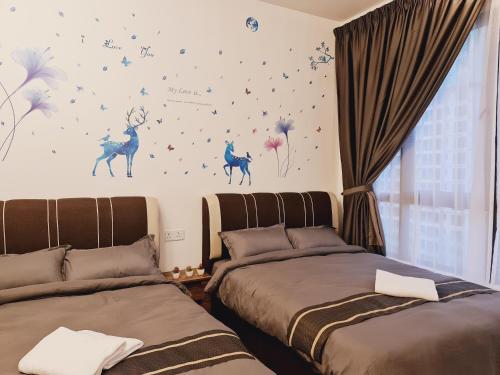 a bedroom with two beds and stars on the wall at Bali Residence Melaka Condo in Melaka