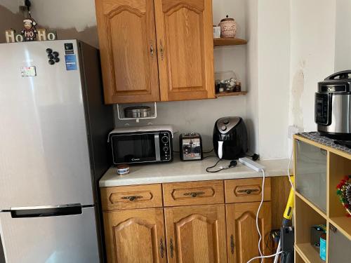 a kitchen with a refrigerator and a microwave at 3 Mayfield rd in Tipton