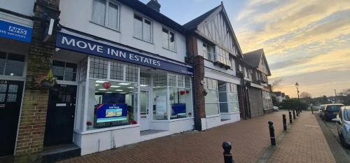 a building with a movie inn signs on a street at Move inn Estates - Multiple Rooms in London