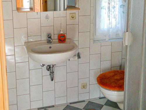 a bathroom with a sink and a toilet at Bungalow am Waldrand in Barth