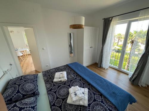 a bedroom with a bed with two towels on it at Seaview Apartment Villa Sia in Vantačići