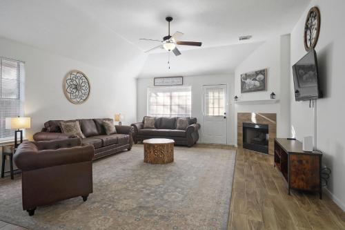 a living room with two couches and a fireplace at IAH Place: 4 bed, patio-sleeps 8+ in Humble
