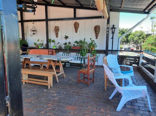un patio con sillas, mesas, mesa y sillas en Cedro Departamentos Temporarios, en Posadas