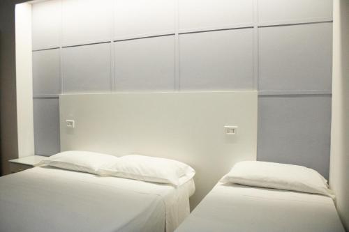 Кровать или кровати в номере Albergo Altamira