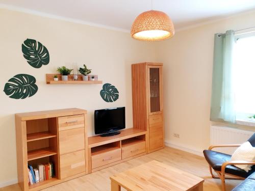 a living room with a tv and a couch at Ferienhaus Hahn in Bad Frankenhausen