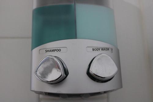 a close up of a soap dispenser on a wall at Comfy 3 BR - Family Friendly Apt - City Access in Pittsburgh