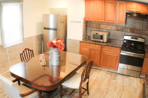 a kitchen with a dining table and a refrigerator at Comfortable Apartment - Pittsburgh's Little Italy in Pittsburgh