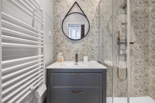 une salle de bain avec un lavabo et un miroir dans l'établissement Orient Express, à Paris