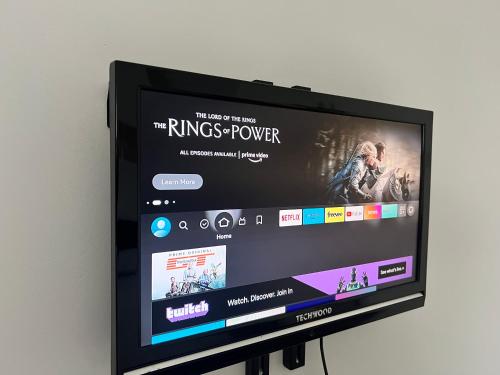 a flat screen tv with a movie on it at Beautiful Double Room for One Person in Bromley