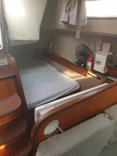 a small room with two beds and a desk at Détente insolite sur un bateau a Cabourg in Dives-sur-Mer