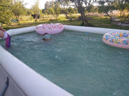 a person in a pool of water with three inflatables at Relax in the Haute Vienne. in Séreilhac