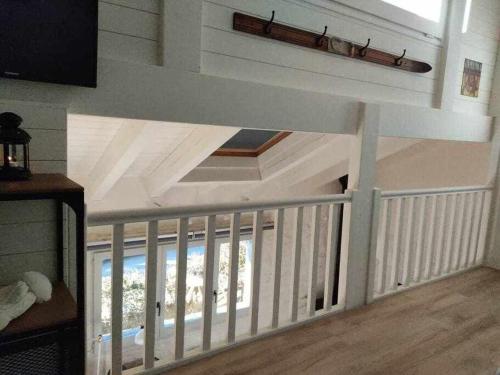 a room with a staircase with a white ceiling at La petite Maison d'Enveitg in Enveitg