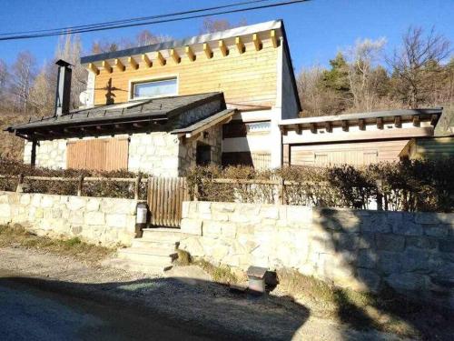 a house with a fence and a garage at La petite Maison d'Enveitg in Enveitg