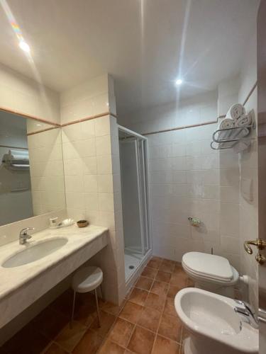 a bathroom with a sink and a toilet at Hotel La Lampara in Reggio Calabria