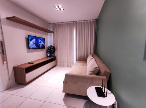 a living room with a couch and a table at VG Sun Cumbuco Sea Breeze Vista Mar in Cumbuco