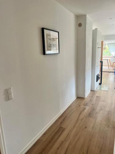 an empty living room with white walls and wood floors at ReinuHome in Viljandi