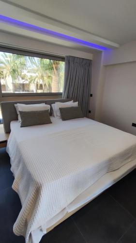 Ένα ή περισσότερα κρεβάτια σε δωμάτιο στο Summertime Signature Suites