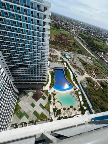 an aerial view of a building with a pool at Suelo at Azure North Pampanga in San Fernando