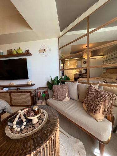 a living room with a couch and a table at Suēlo at Azure North Pampanga in San Fernando