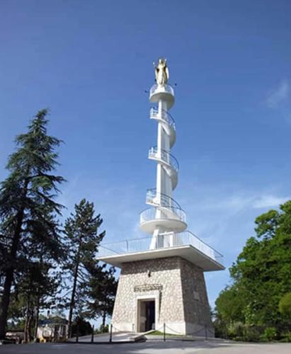 a lighthouse with a statue on top of it at Appartamento monolocale Fiuggi 14 MQ piscina dal 20 giugno al 15 settembre in Fiuggi